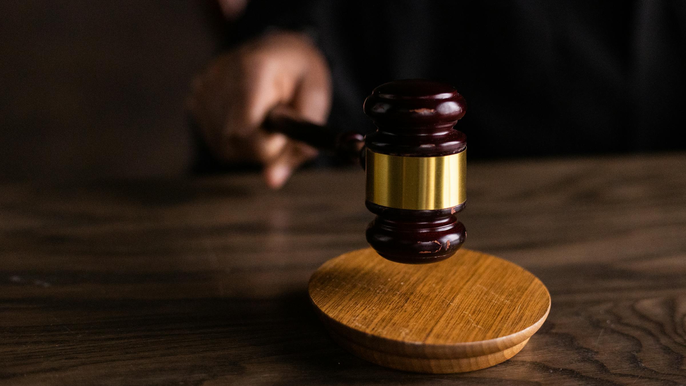 Martelo de juiz sobre bloco de som, simbolizando uma decisao judicial