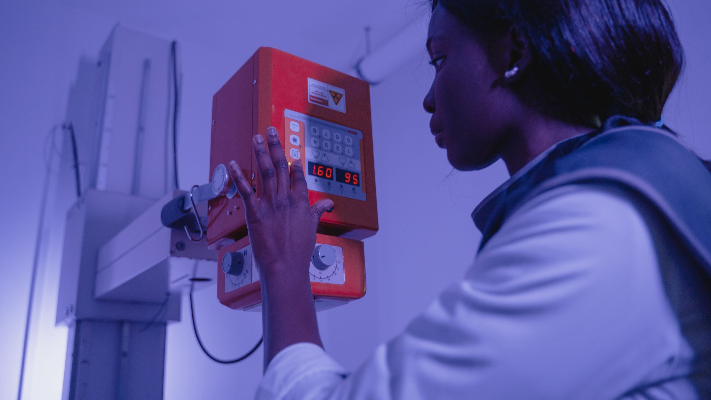 Radiologic technologist operating an X-ray machine