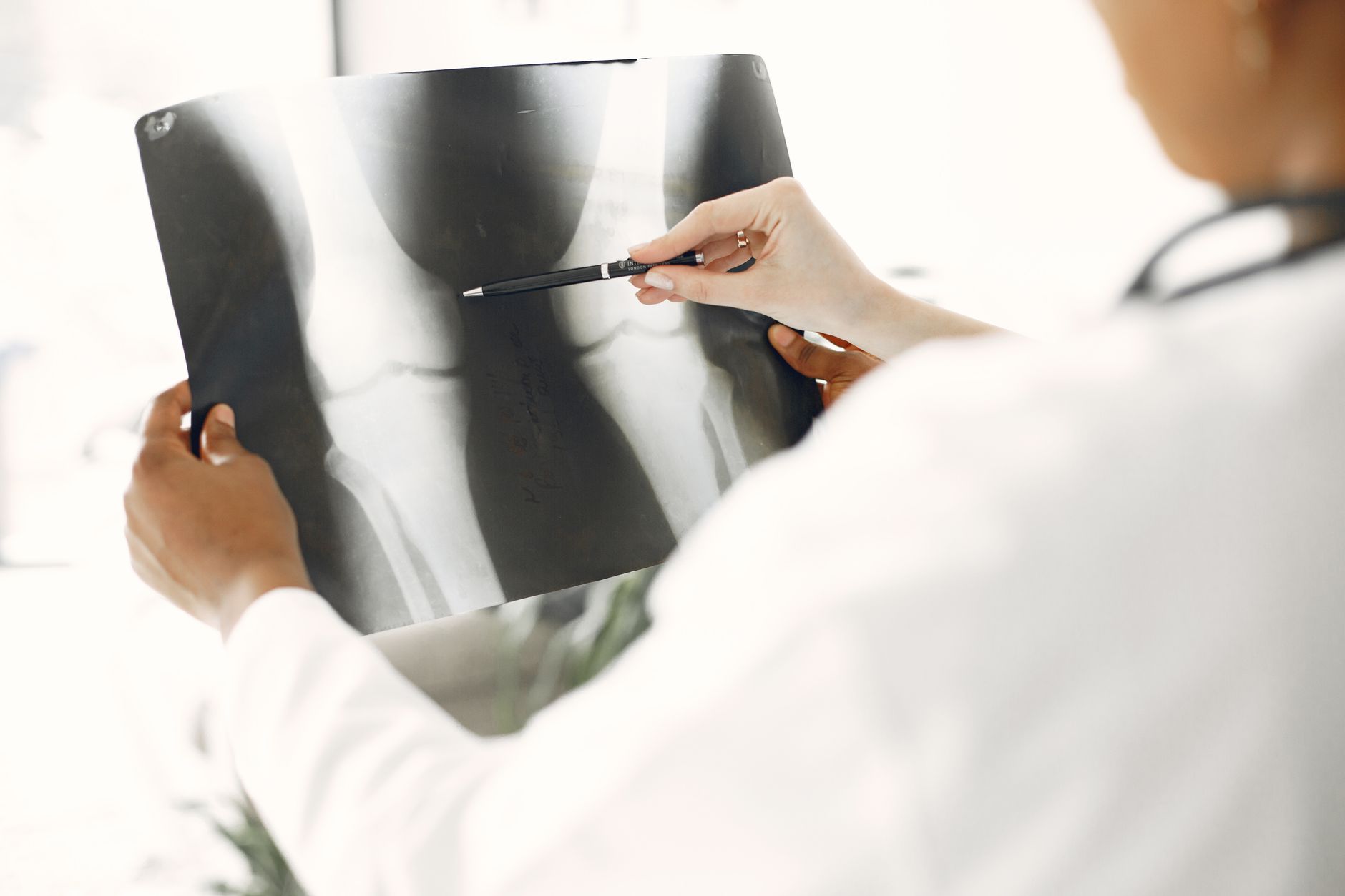Médico analisa imagem radiográfica para laudo remoto em fluxo de telerradiologia