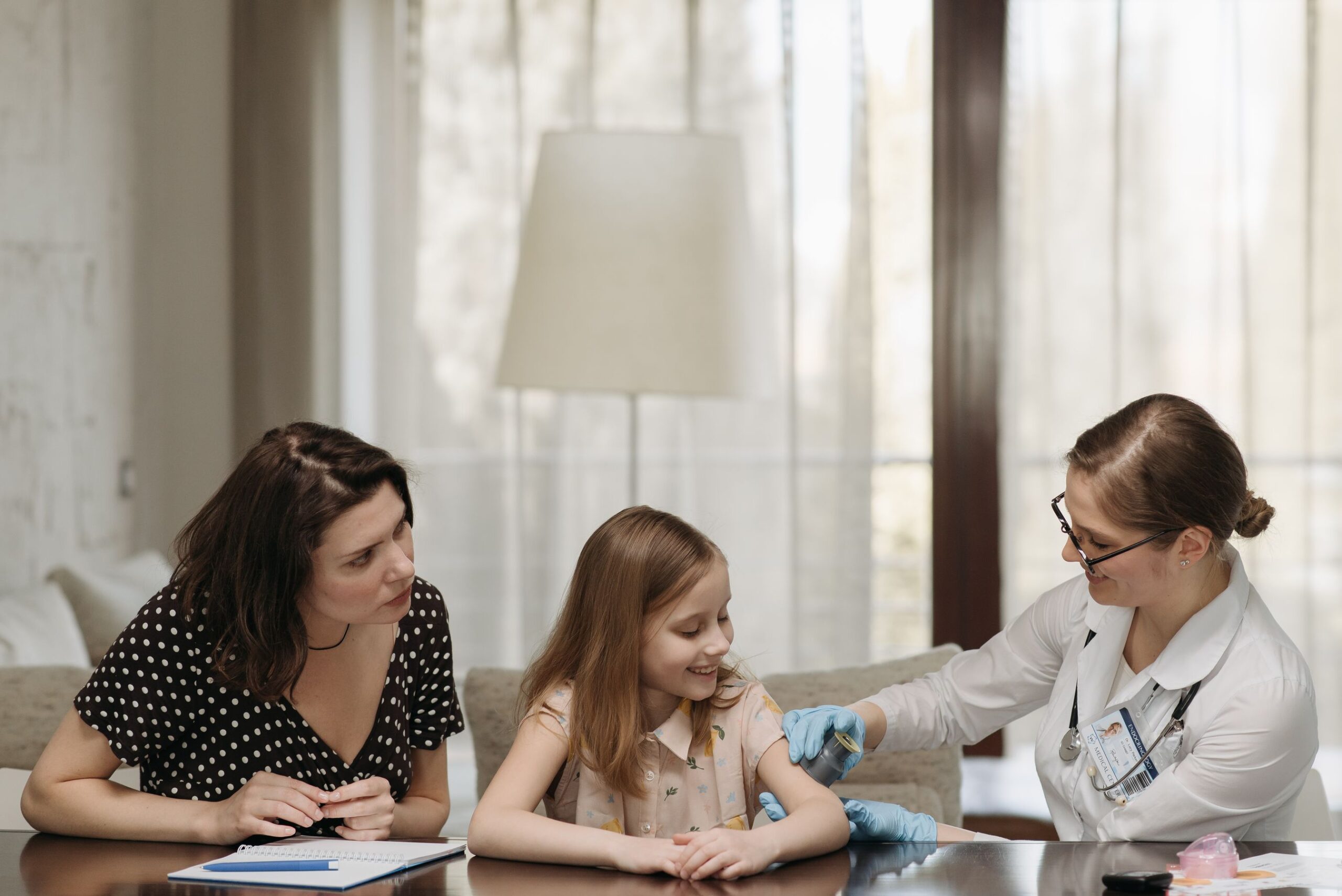 Mother and daughter reviewing a pediatric imaging result during a medical consultation